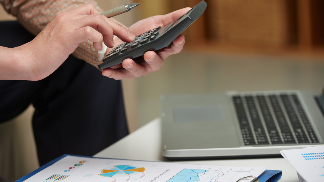 man taking accounts on the calculator